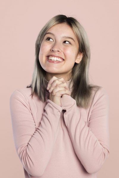 Happy woman in a pink turtleneck